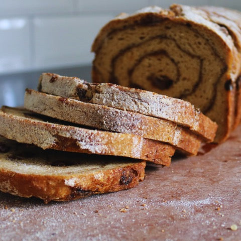Sliced bread with a swirl pattern on a wooden surface